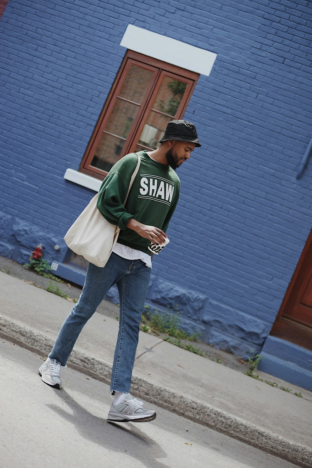 Man in green and white hoodie standing near blue wall photo – Free Clothing  Image on Unsplash