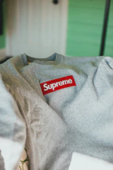 gray crew neck shirt on white table