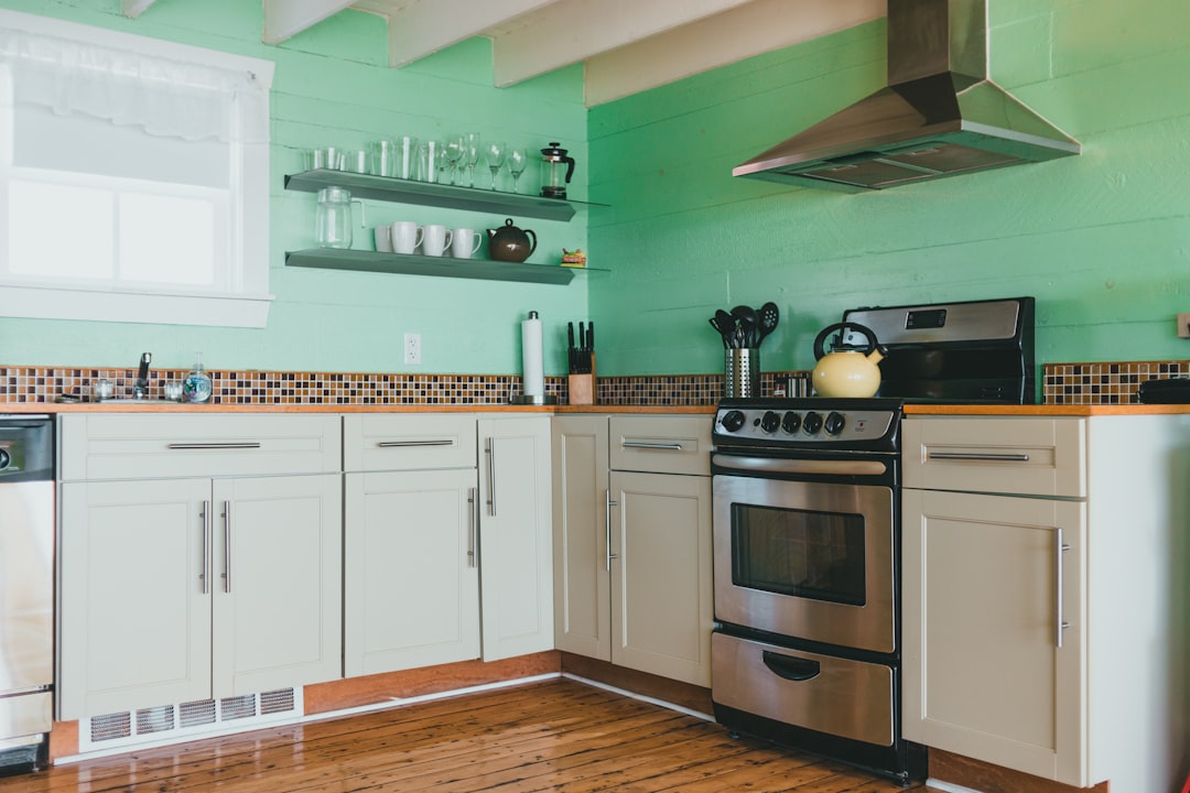 white wooden kitchen cabinet with black and silver gas stove