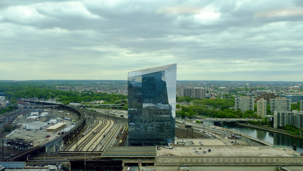 a very tall building sitting next to a train track