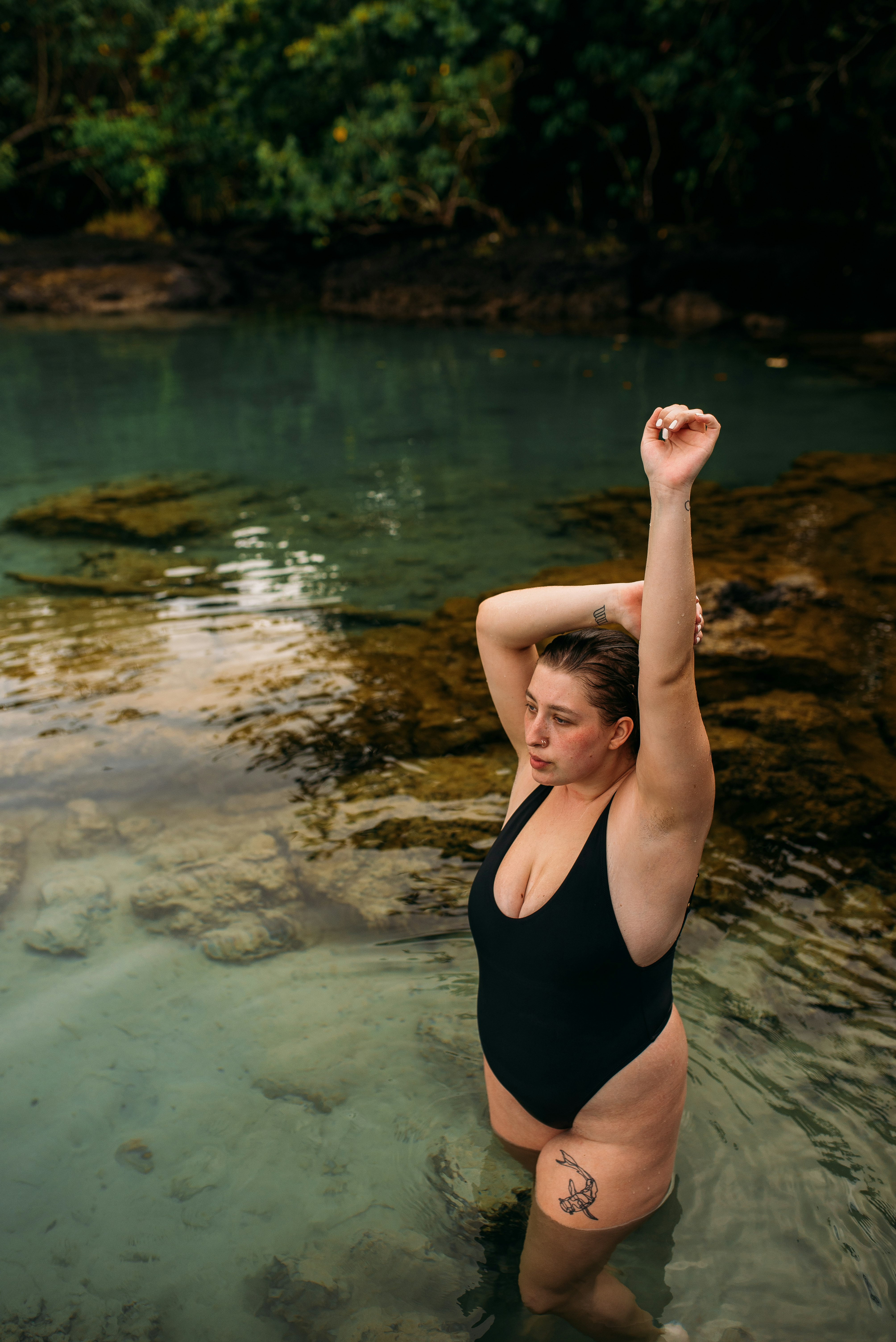 woman in black one piece swimsuit in water