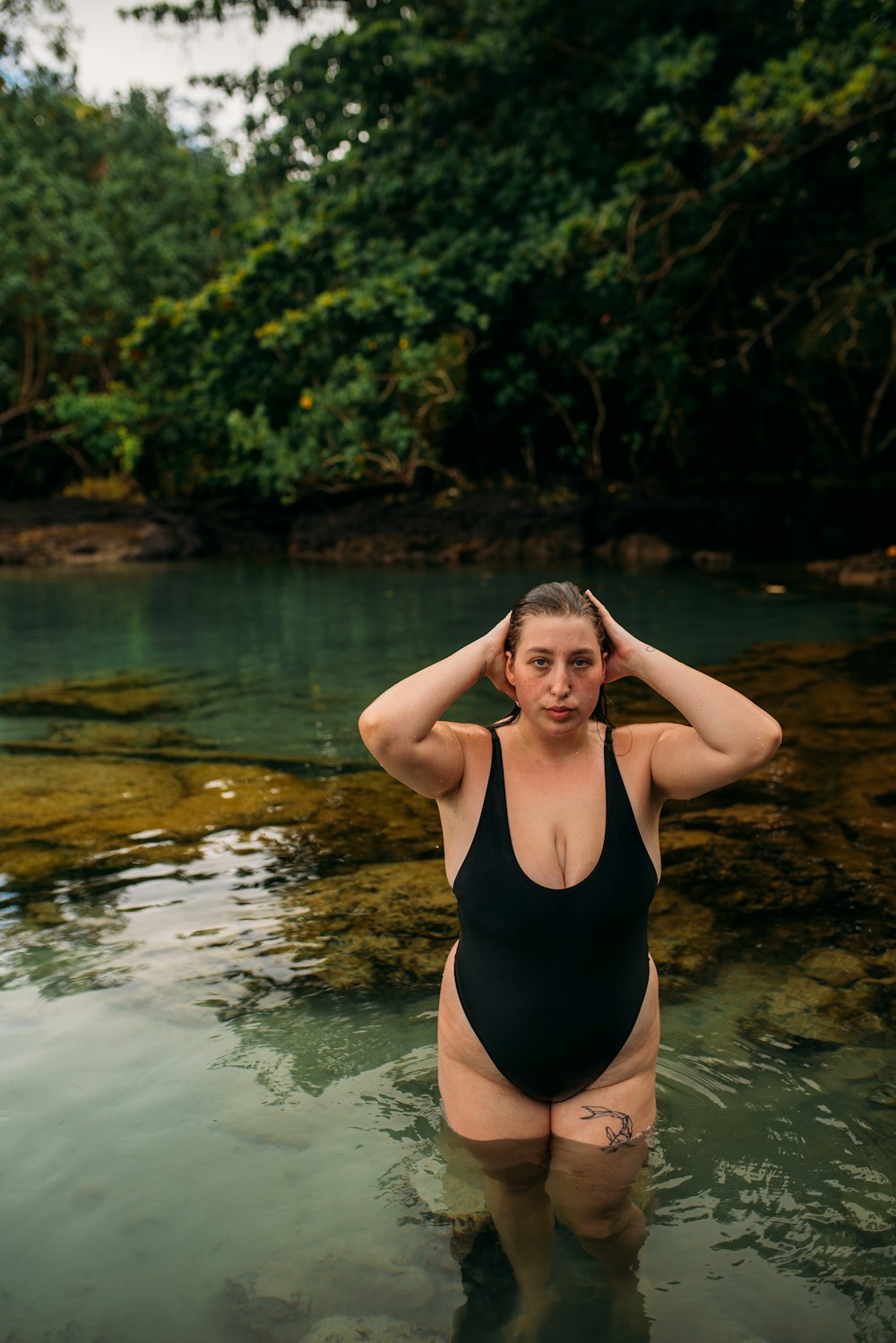 woman in black one piece swimsuit in water