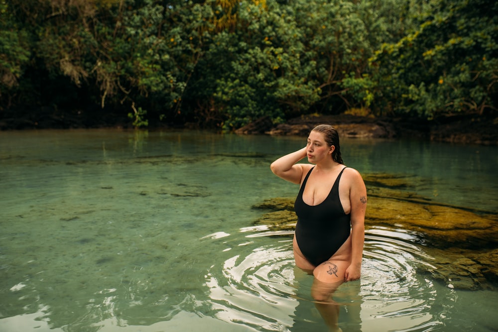 woman in black one piece swimsuit in water