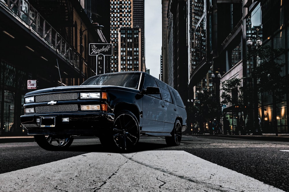 a black truck parked on the side of the road