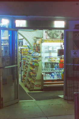 Entrance of a modern autonomous minimarket inside a residential condominium lobby.