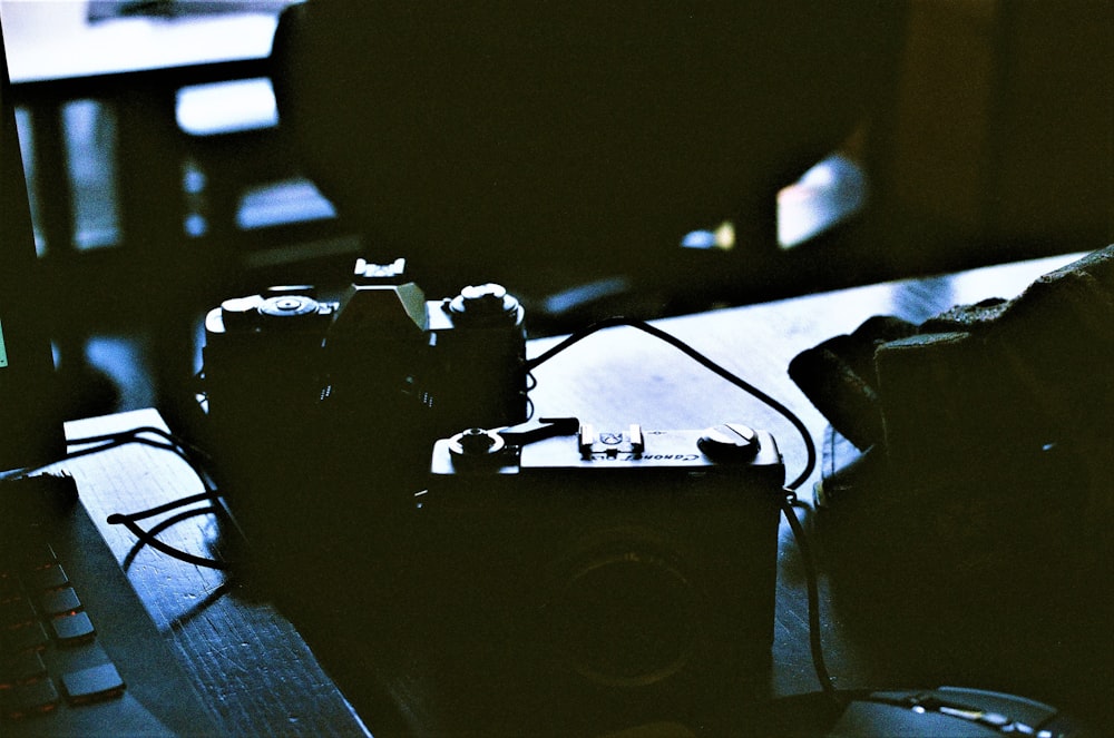 a couple of cameras sitting on top of a table