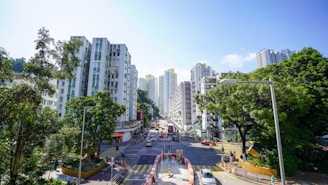 SPR Road bustling with apartments and local shops under a clear sky.