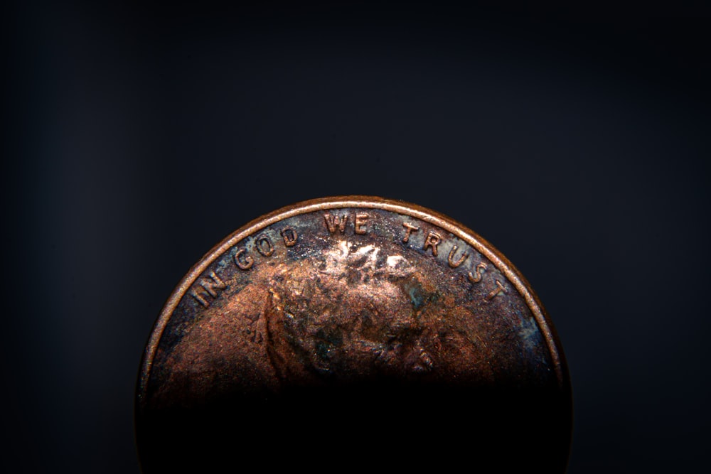 a close up of a penny on a black background