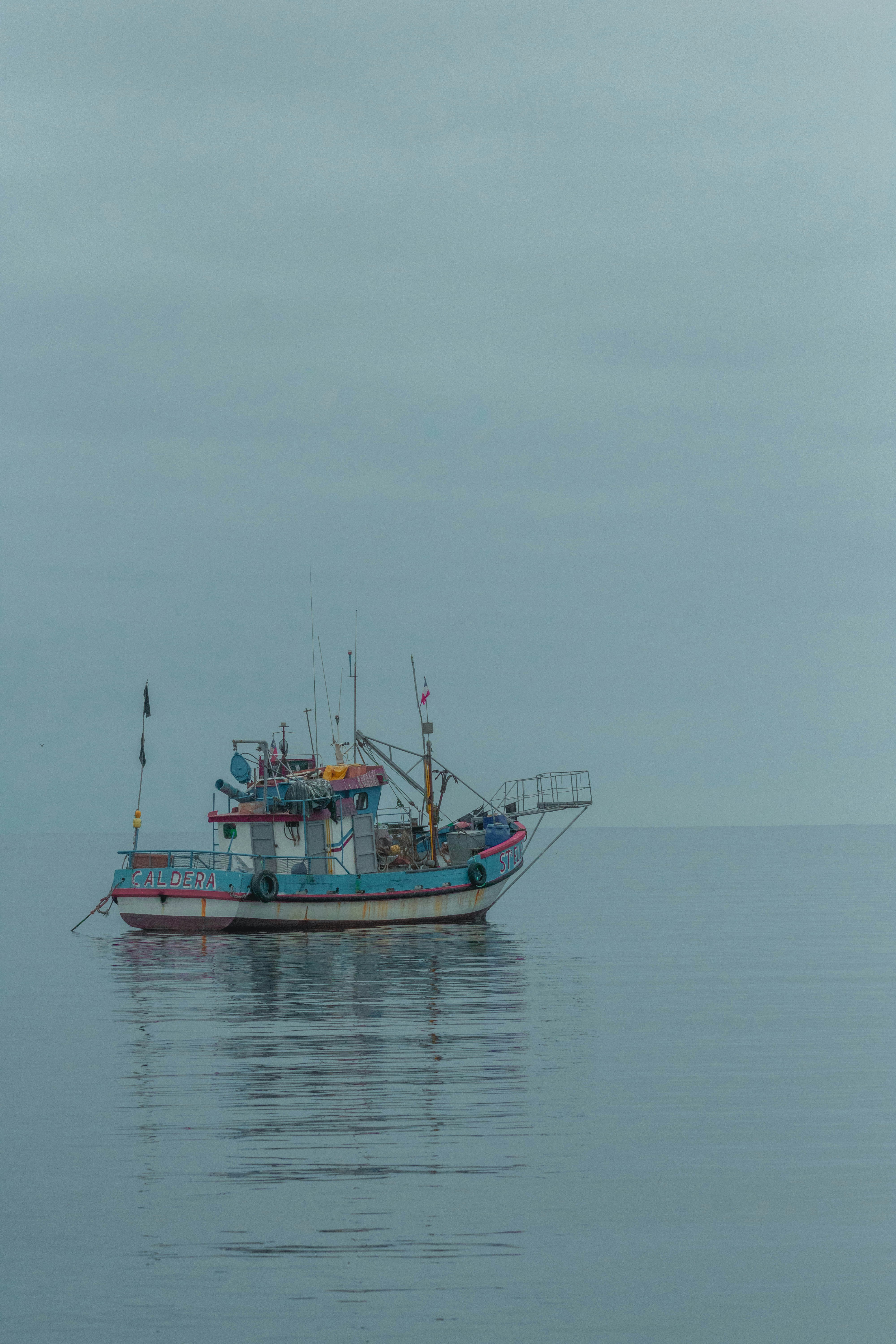 a fishing boat in the middle of the ocean
