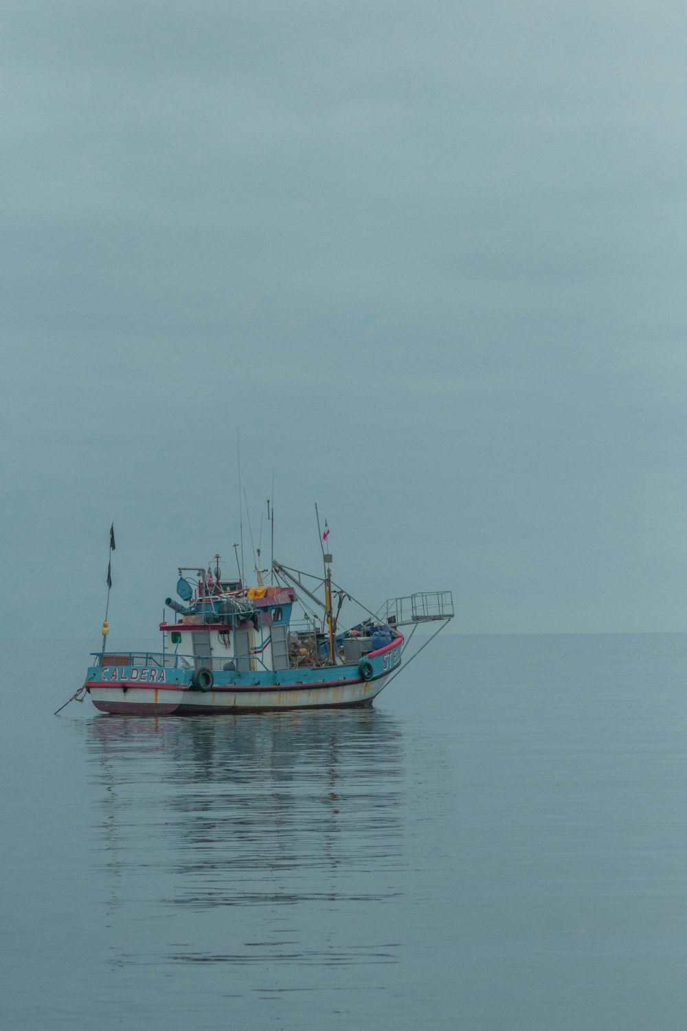 a fishing boat in the middle of the ocean