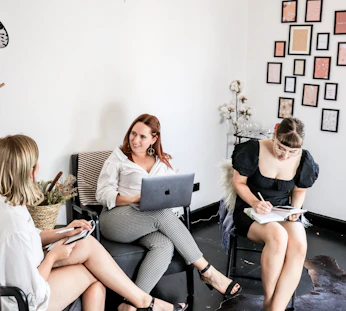 woman in black tank top sitting on black couch
