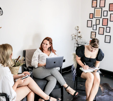 woman in black tank top sitting on black couch
