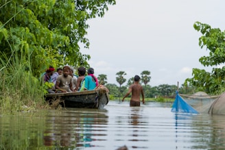 a group of people in a boat on a river