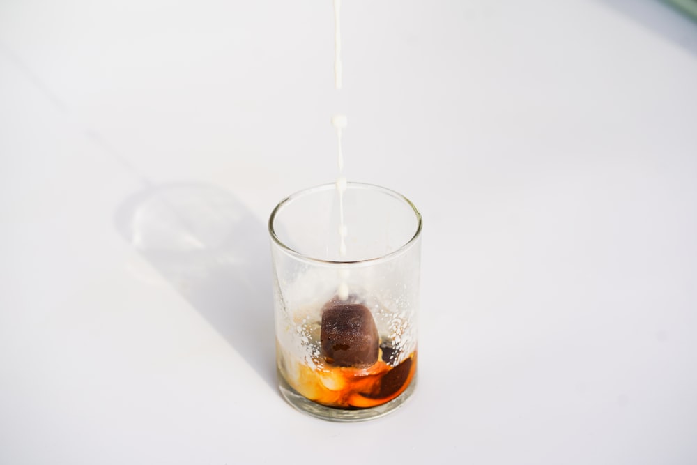 clear drinking glass with brown liquid