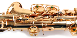 Close-up of a skilled technician carefully repairing a saxophone with precision tools.