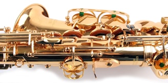 A close-up view of a brass saxophone showcasing intricate mechanical components and shiny golden surfaces.
