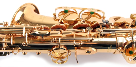 A close-up view of a brass saxophone showcasing intricate mechanical components and shiny golden surfaces.