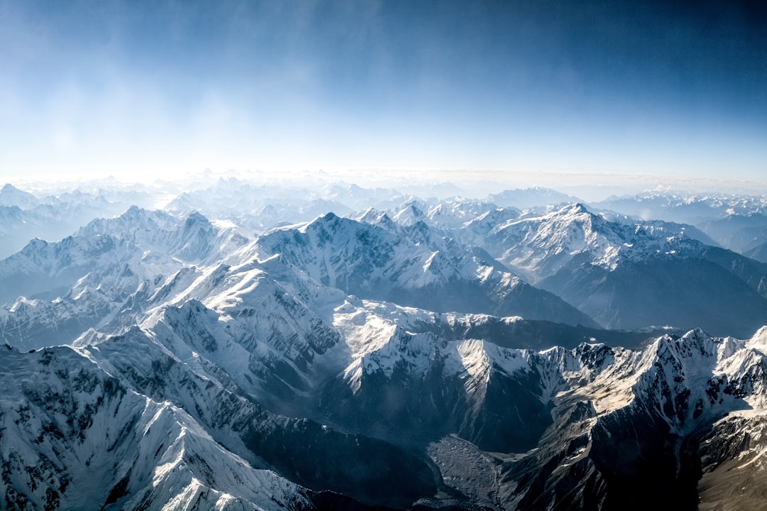 snow covered mountains under blue sky during daytime