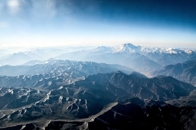 aerial view of mountains during daytime vast zoom background
