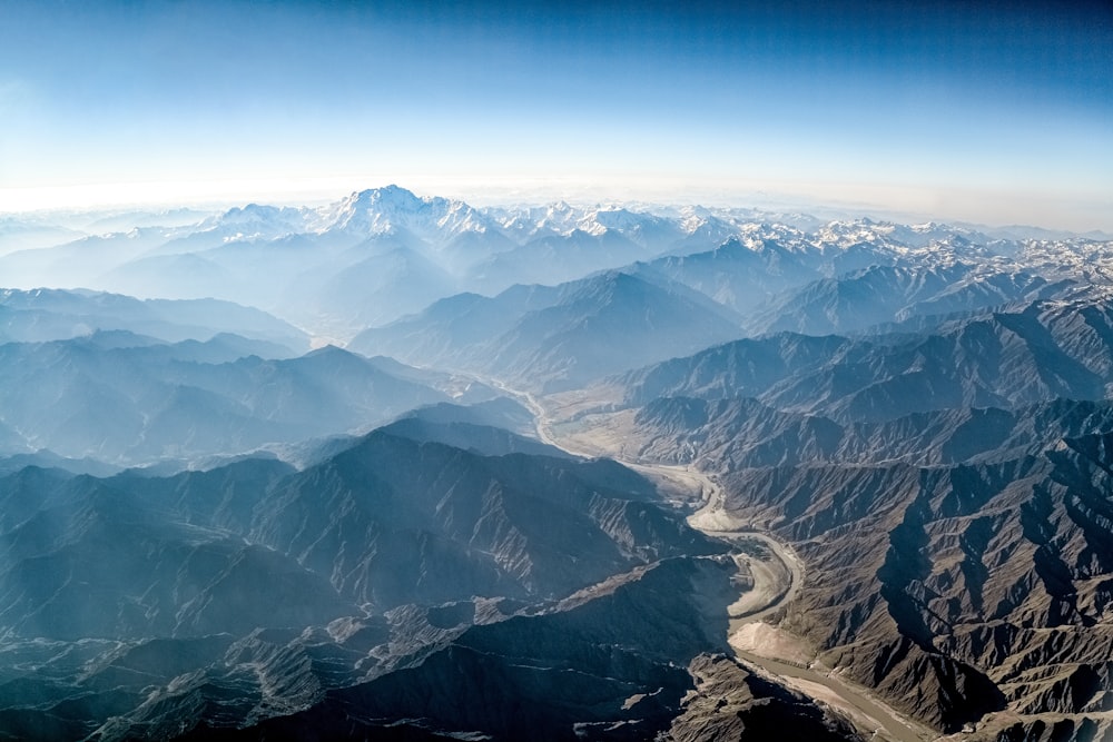 aerial view of mountains under blue sky during daytime