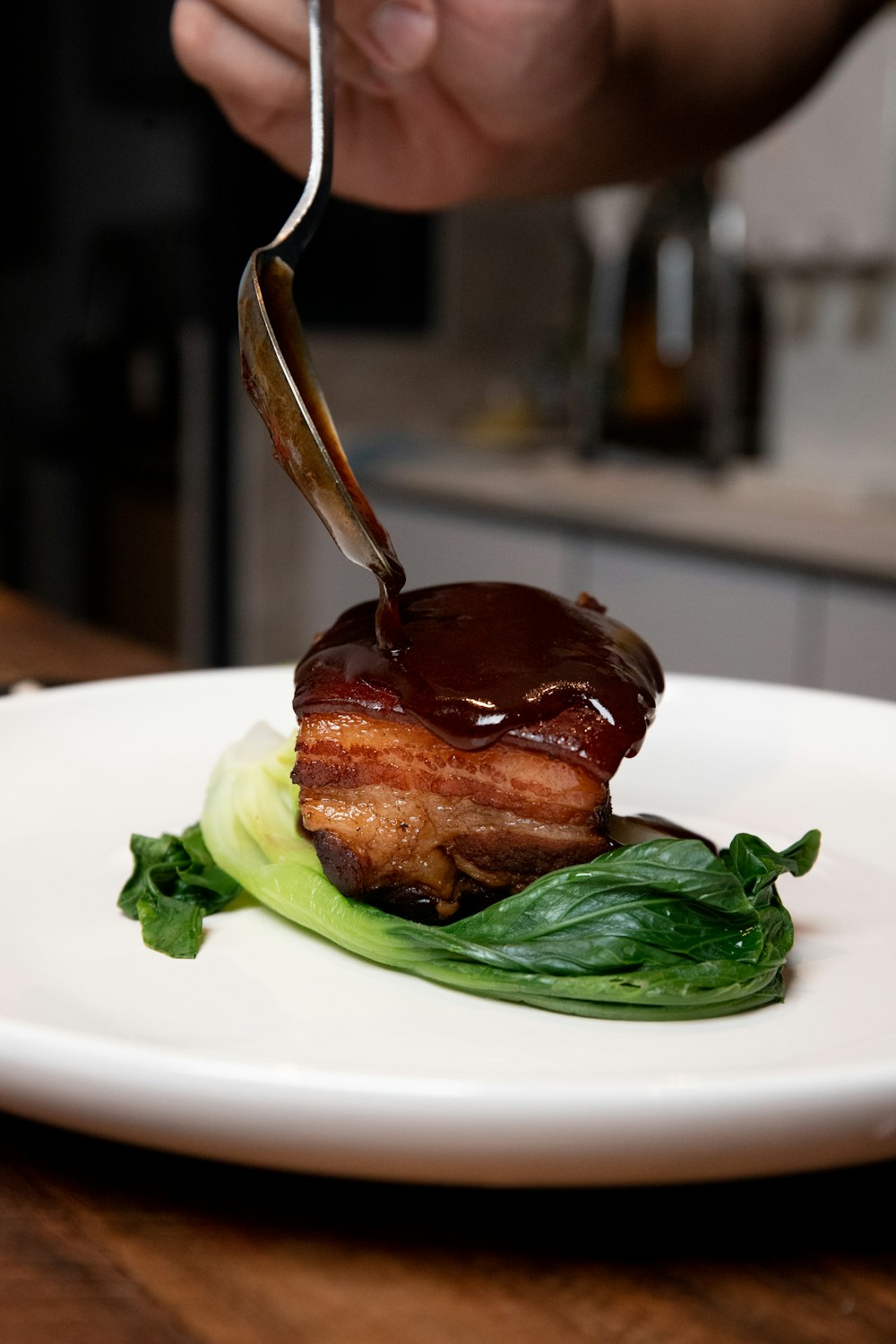 a person cutting into a piece of meat with a knife