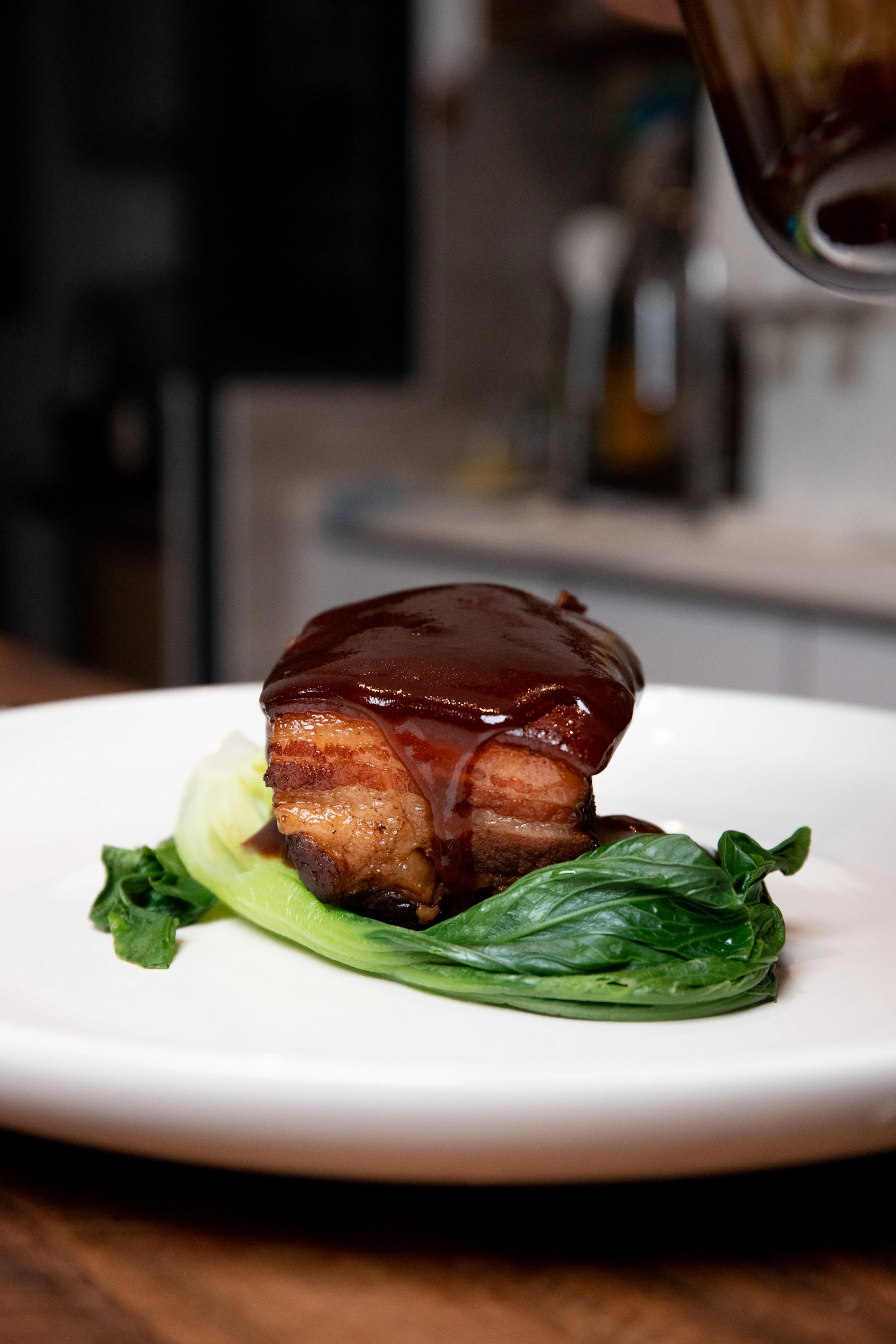 Glossy red-braised pork belly in a dark pot