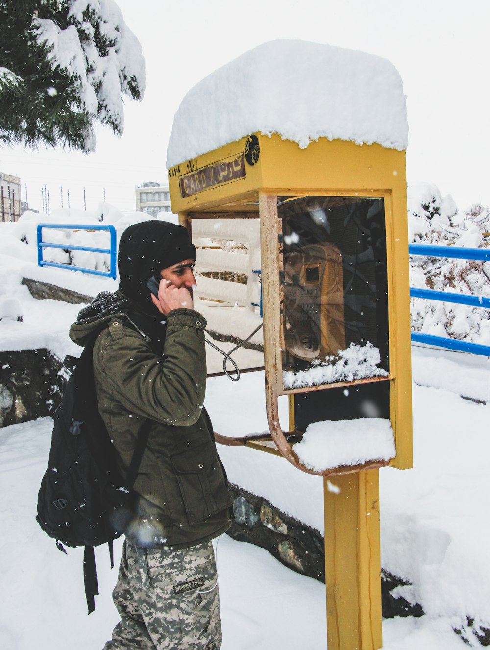 a man in camouflage talking on a cell phone