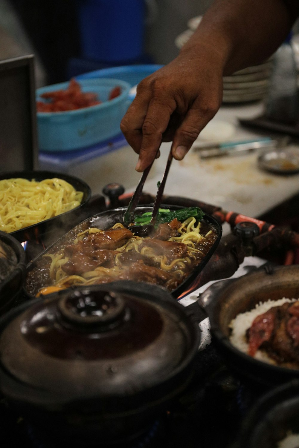 a person cutting a piece of food with chopsticks