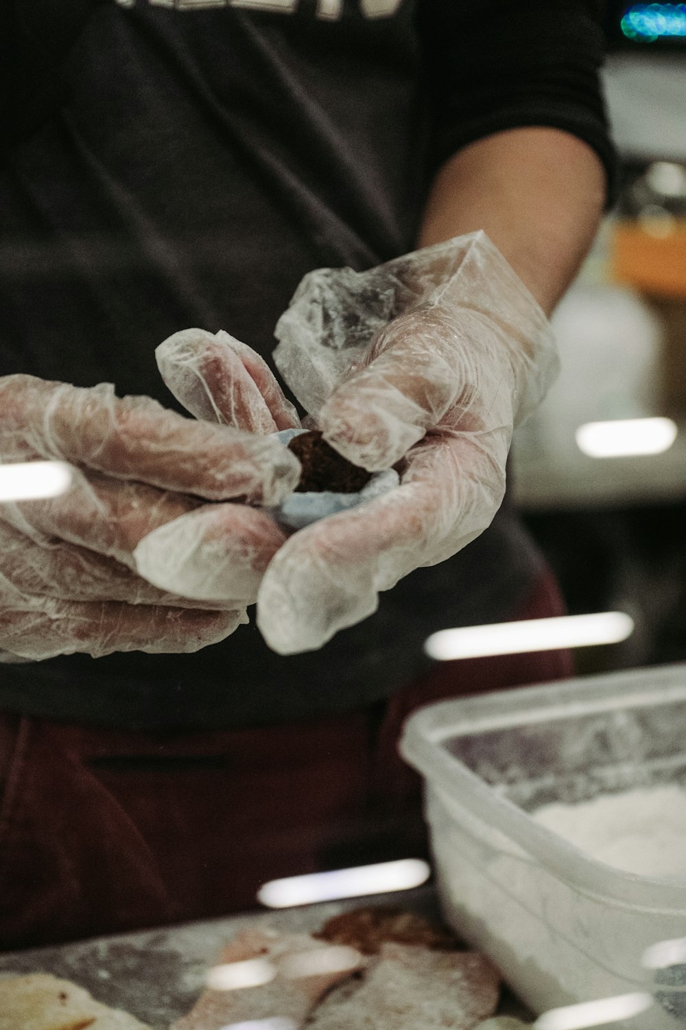 a person wearing gloves holding something in their hands