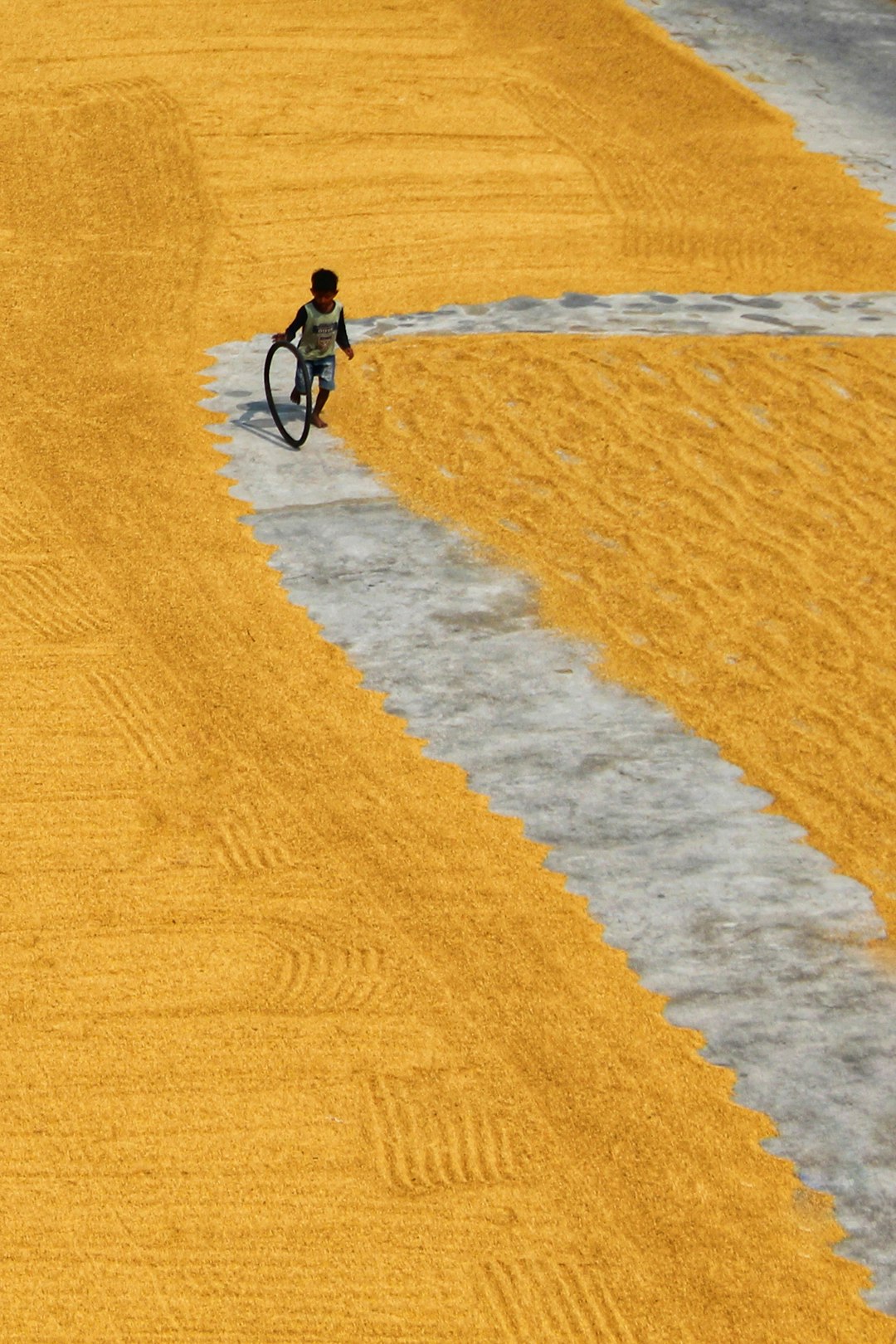 man in black shirt riding bicycle on brown sand during daytime