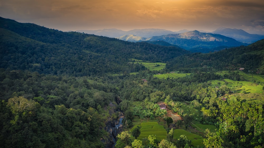 a view of a valley with a waterfall in the middle of it