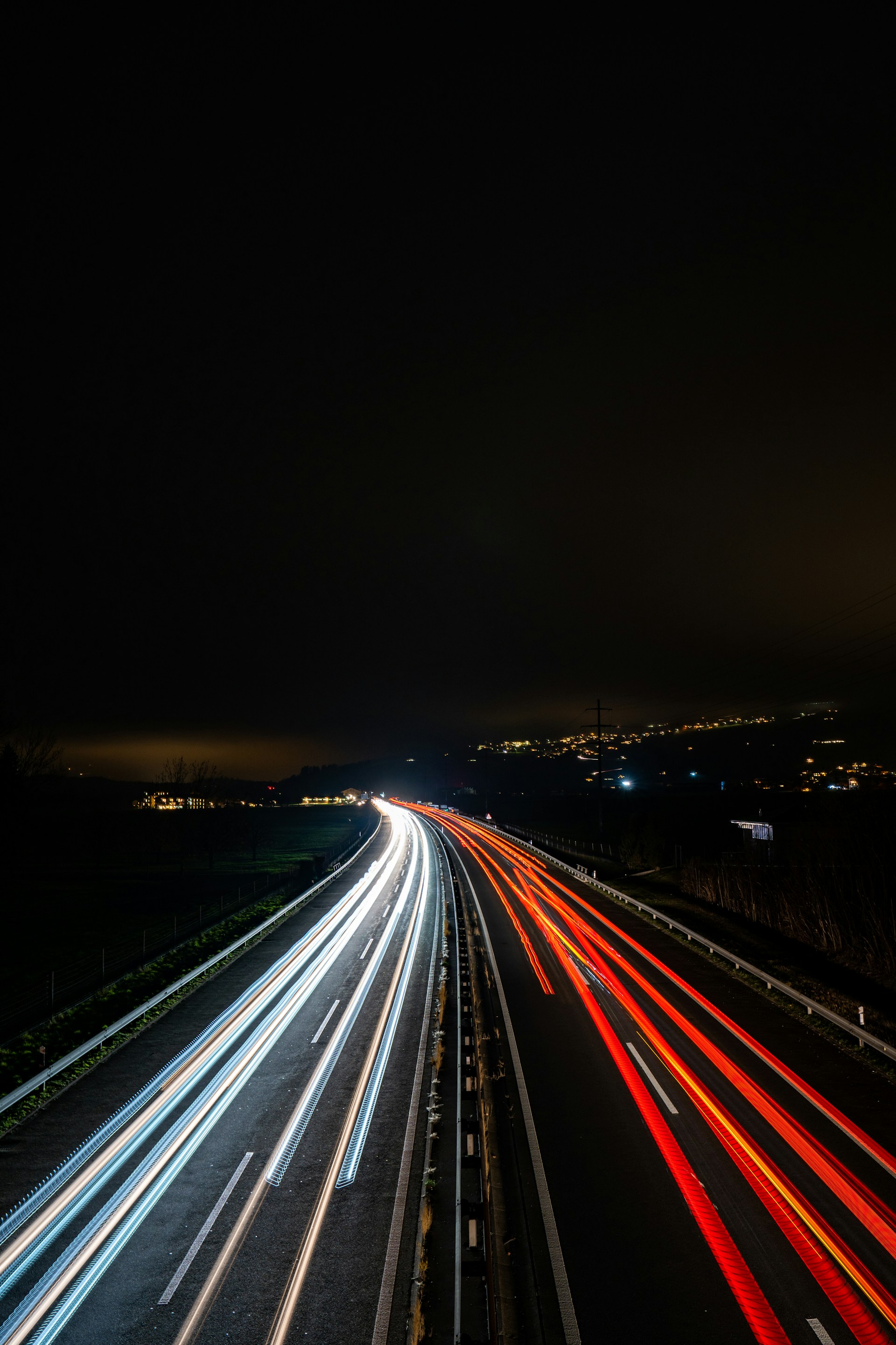 a long exposure photo of a highway at night