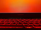 Lenovo's logo illuminated on a high-tech laptop screen.