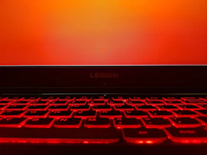 Lenovo's logo illuminated on a high-tech laptop screen.