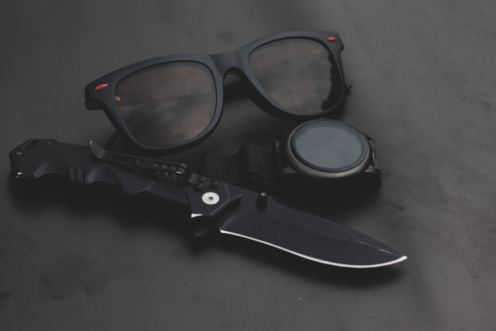 a pair of sunglasses and a knife on a table