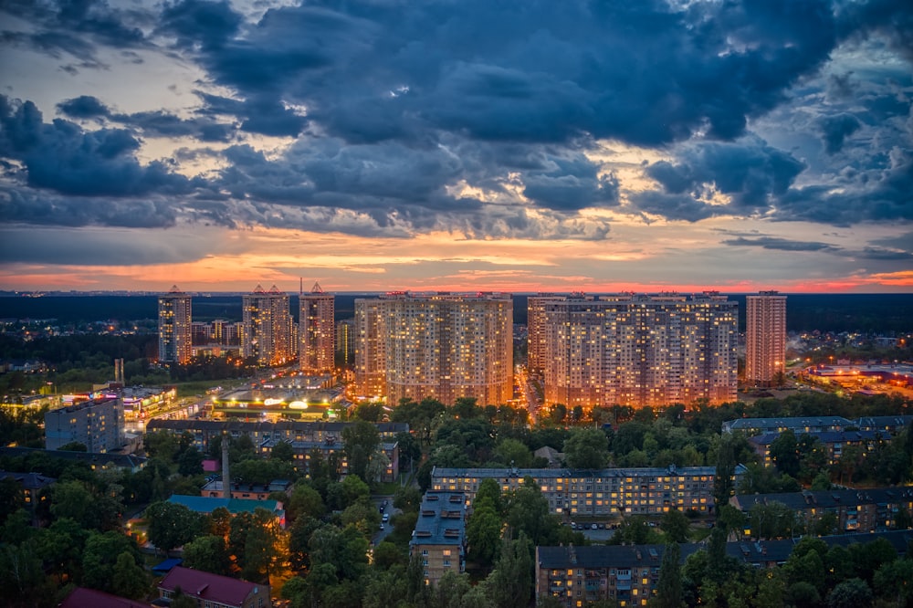 city with high rise buildings under blue sky during night time