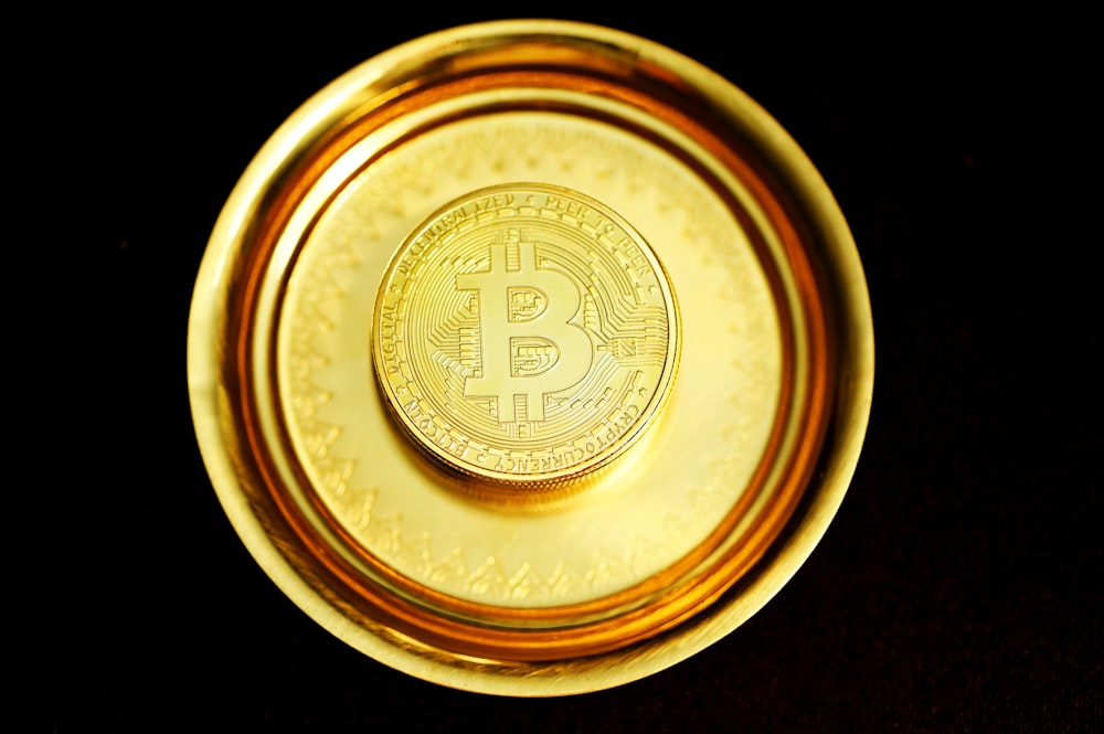 a gold plate with a bit coin on it