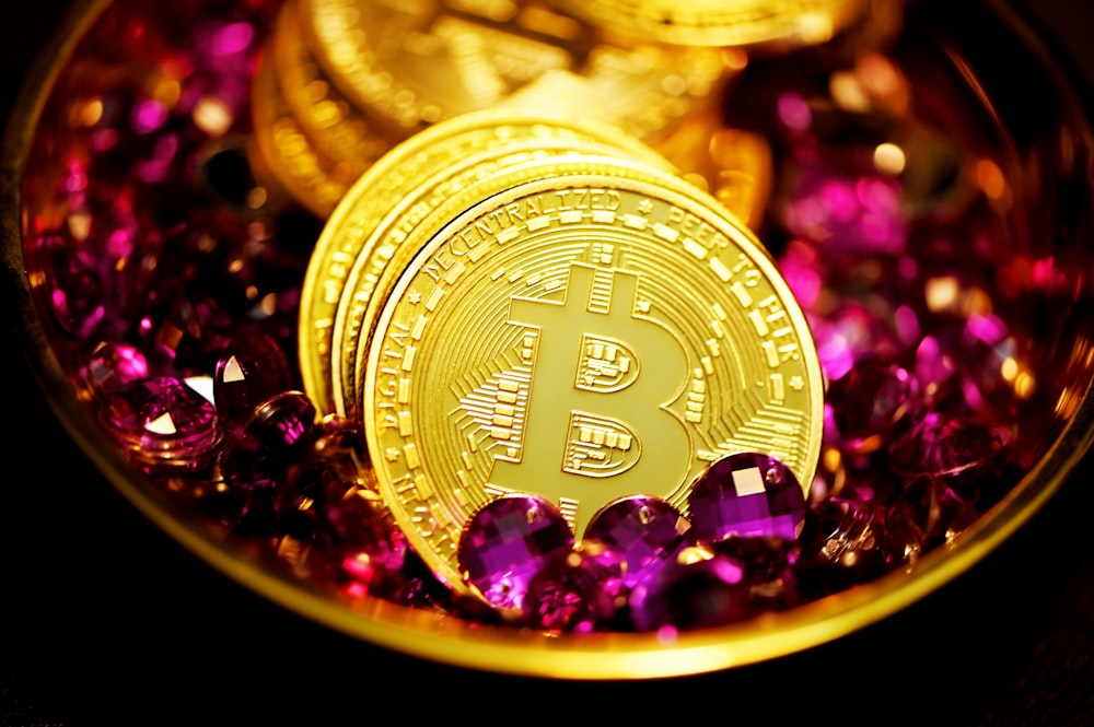 a close up of a bitcoin surrounded by purple crystals