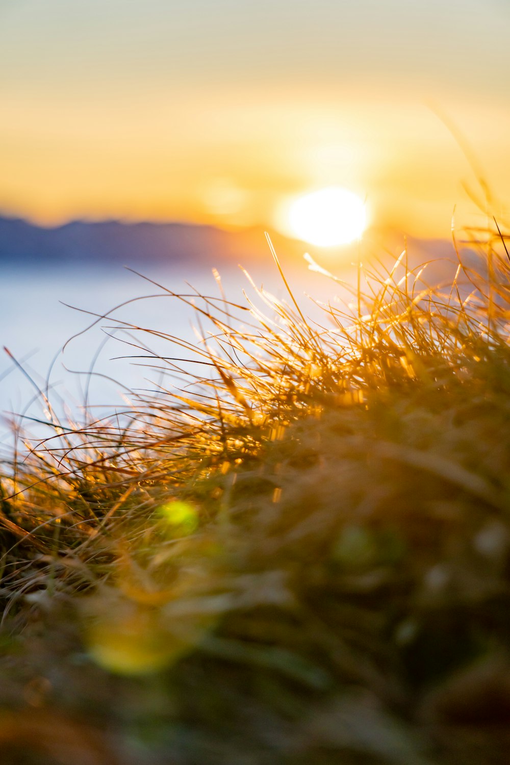 the sun is setting over a body of water