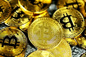 a pile of gold bitcoins sitting next to each other