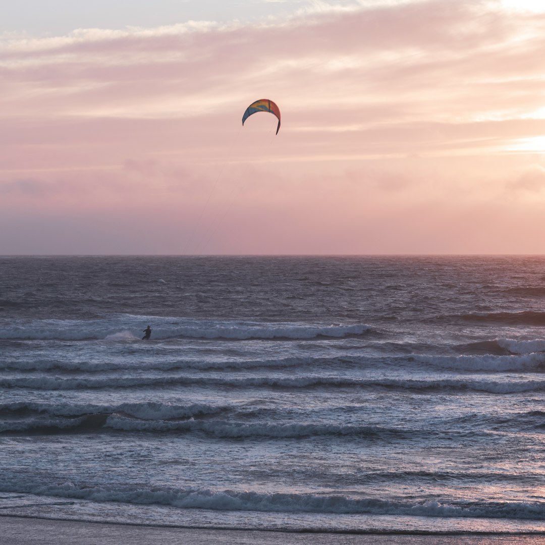 person surfing on sea waves during daytime