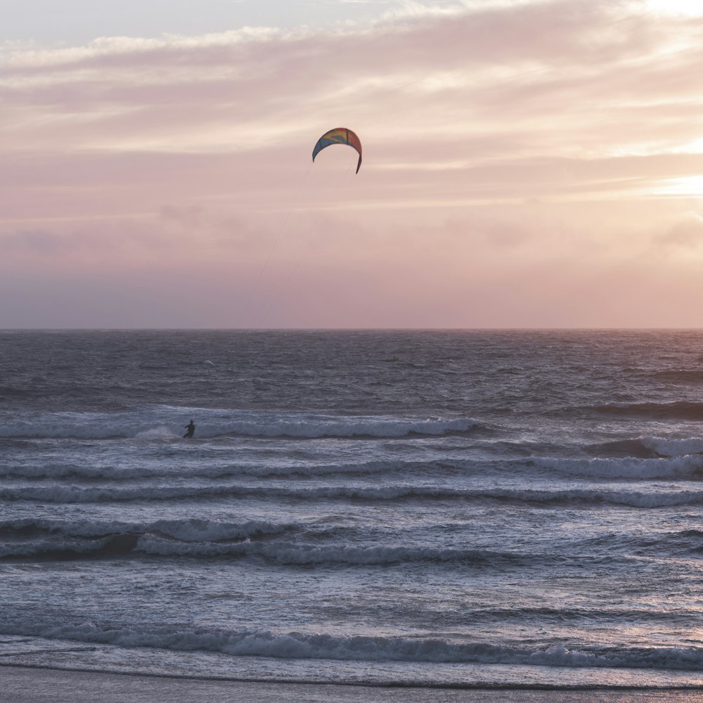 person surfing on sea waves during daytime