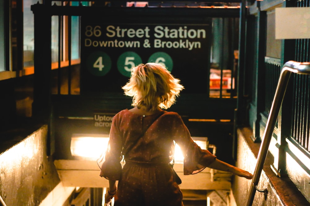 a woman walking up a flight of stairs