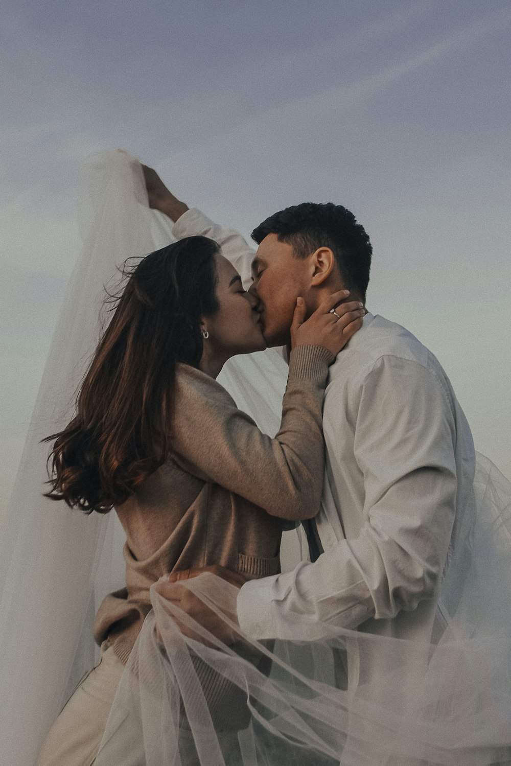 a man and a woman kissing each other