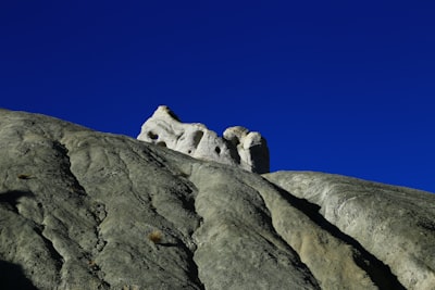 white and black rock formation under blue sky during daytime sculptural zoom background