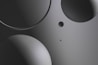 Various circular shapes in different sizes are positioned on a smooth, gradient background. The image primarily uses shades of gray, with a sleek and modern look.