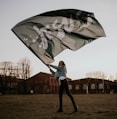 man in white jacket holding umbrella