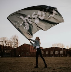 man in white jacket holding umbrella