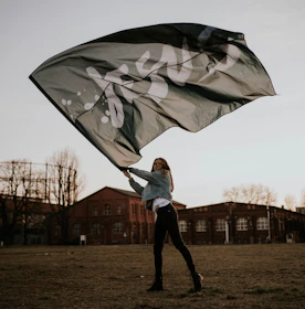 man in white jacket holding umbrella