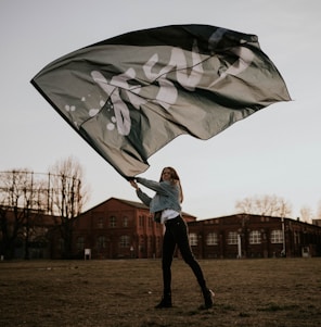 man in white jacket holding umbrella